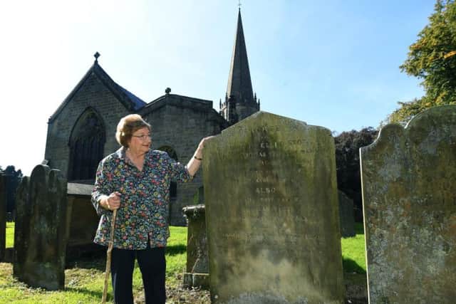 Family historian Denny Gibson has discovered a link between Boris Johnson and Jeremy Corbyn, whose ancestors both lived in Masham in the early 1800s. Pictured in the church yard of The Church of St Mary the Virgin, Masham, looking at a headstone belonging to Thomas and Ellen Stott, the great-great-grandparents of Jeremy Corbyn. Picture: Jonathan Gawthorpe