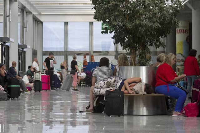 Stranded holiday-makers wait for news after the collapse of Thomas Cook.