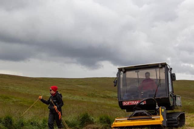 National Trust Rangers cutting vegetation breaks on Marsden Moor to try and stop future fires from spreading.