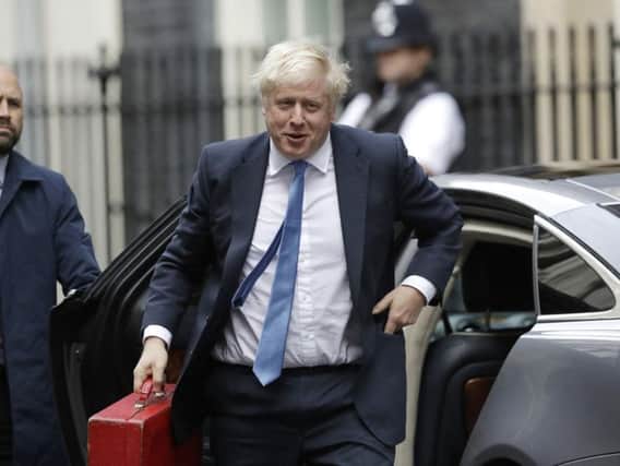 British Prime Minister Boris Johnson arrives at Downing Street in London. Photo: PA Photo/Matt Dunham