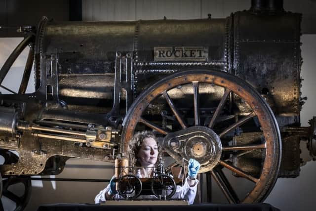 Lead Conservator Wendy Somerville-Woodiwis with Stephenson's Rocket and a model locomotive as she unveils the Rocket's new home, the National Railway Museum in York, where it will be on display until April next year. PA Photo.