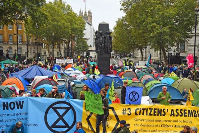 Extinction Rebellion (XR) protesters camp in tents around the Monument to the Women of World War II on Whitehall in Westminster, central London, as the climate change protest continued.