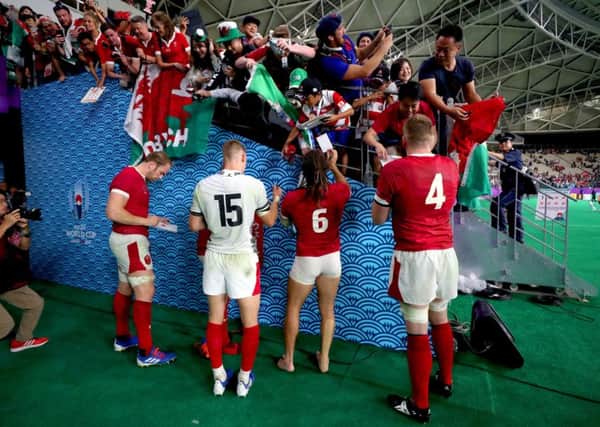 Wales players sign autographs for fans at the end of the 2019 Rugby World Cup Pool D match at Oita Stadium, where England's game with France could be moved to (Picture: David Davies/PA Wire)