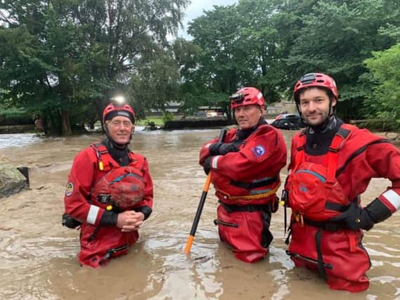 Pete Roe, Dave Rutter and Adam Bradley, of Swaledale Mountain Rescue Team, waist deep in flood water in the village of Fremington. Picture by Swaledale Mountain Rescue Team.