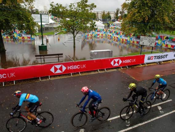Riders pass the flooded fan zone on the Stray, Harrogate during the UCI World Championships 2019.