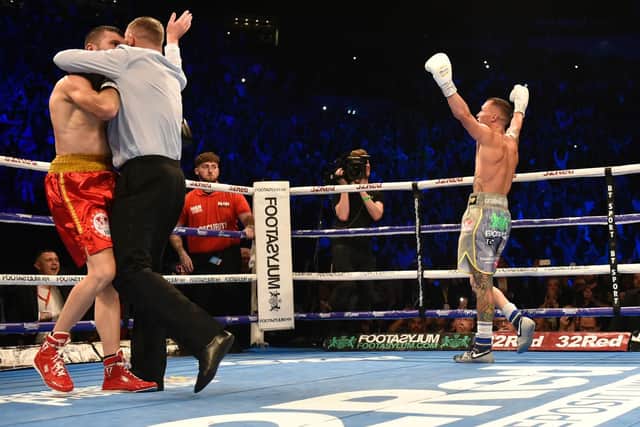 Josh Warrington celebrates as the fight is waved off. PIC: Steve Riding.