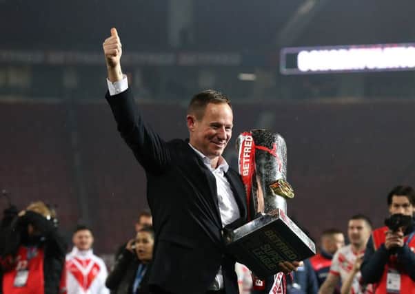 St Helens coach Justin Holbrook (centre right) lifts the trophy after the final whistle in the Super League Grand Final at Old Trafford. Picture: Martin Rickett/PA