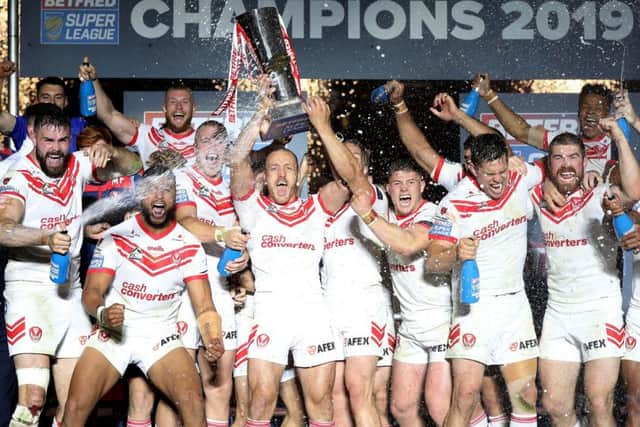 St Helens' James Roby lifts the trophy at Old Trafford. Picture: Martin Rickett/PA