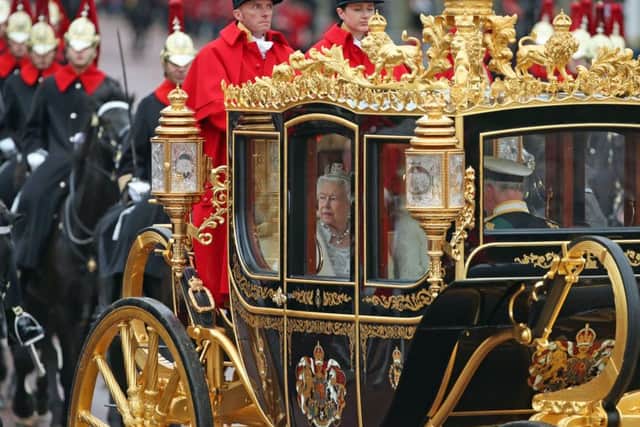 Queen Elizabeth II, accompanied by the Duke and Duchess of Cornwall, returns to Buckingham Palace, London, in the Diamond Jubilee State Coach, having delivered The Queen's Speech.