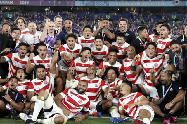 Japan players and management celebrate after defeating Scotland 28-21 in their Rugby World Cup Pool A game at International Stadium in Yokohama. (AP Photo/Christophe Ena)