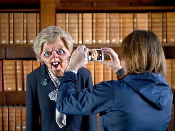A woman takes a photo of a Margaret Thatcher puppet, as the archive of Spitting Image was handed over to the library at Cambridge University in November last year. Credit: Joe Giddens/PA Wire