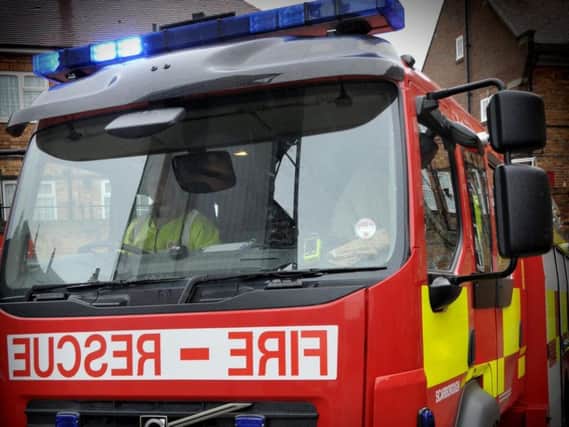 Emergency services have been called to rescue a man trapped in machinery at an East Yorkshire village.