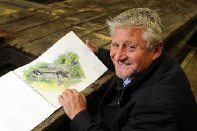 Garden designer Mark Gregory with the plans for his 2019 creation. Picture: Tony Johnson