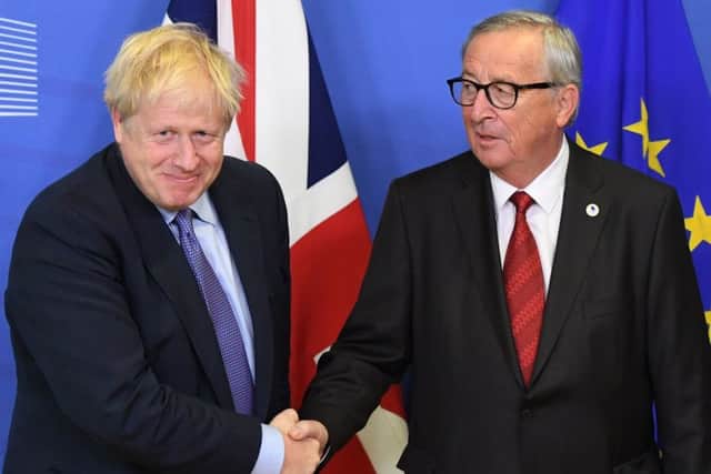 Boris Johnson after striknig a Brexit deal with EU president Jean-Claude Juncker, but will it be backed by MPs?