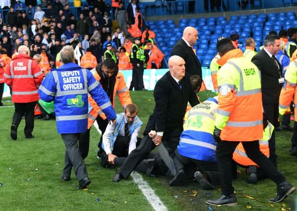 Unwanted scene: Birmingham fans are restrained at full time at Elland Road. 
Picture: Jonathan Gawthorpe