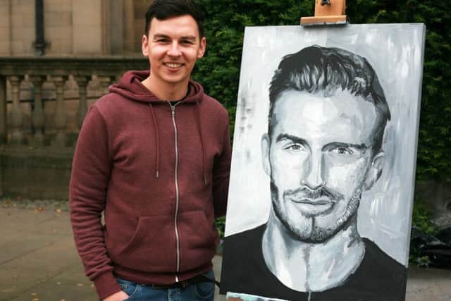 Jamie Wilkinson with the David Beckham portrait, that Sheffield shoppers helped to paint. Photo: CK Goldiing.