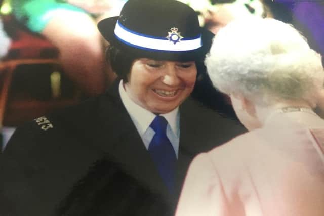 PCSO Liz Smith is pictured receiving her MBE from Her Majesty the Queen in 2010.