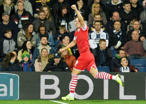 On target: Barnsley's Cauley Woodrow celebrates scoring his side's first goal at The Hawthorns.