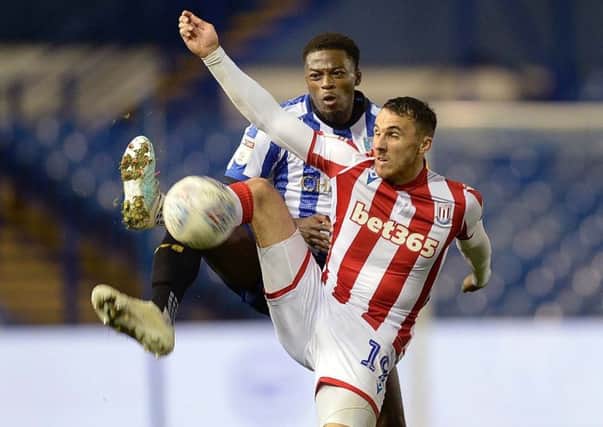 Commanding: Owls' Dominic Iorfa holds up Stoke City's Sheffield-born Lee Gregory. Picture: Steve Ellis