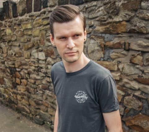 Principle programmer Joe Wilson in Sheffield, wearing an Adventure is Calling t-shirt by the Level Collective and handcrafted jeans from Hiut. Image by Madeleine Winters.