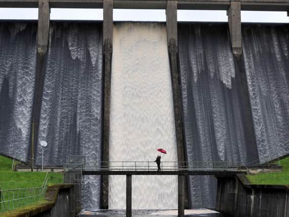 Chris Spencer, Yorkshire Water plant engineer, stood on the footbridge at the bottom of Thruscross Reservoir watching the thousands of gallons of water crashing down the spillway. 

Technical details:  Nikon D3, 1/200 sec, F11 Iso 400, on a 70mm lens.

Photo Gerard Binks.