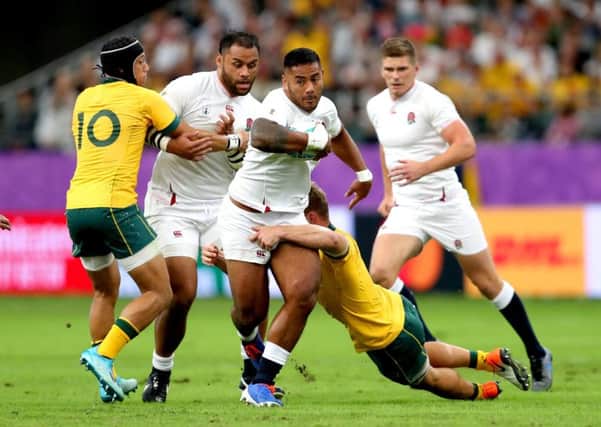 England's Manu Tuilagi (centre) is tackled by Australia's Michael Hooper during the Rugby World Cup Quarter Final match at Oita Stadium. Picture: David Davies/PA