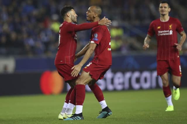 Liverpool's Alex Oxlade-Chamberlain, left, celebrates after scoring the opening goal against Genk. Picture: AP/Francisco Seco