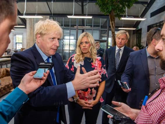 Prime Minister Boris Johnson at Fox Valley Shopping Centre, Stocksbridge, Sheffield. Pictured Prime Minister Boris Johnson, with Miriam Cates, Conservative parliamentary candidate for Penistone & Stocksbridge, South Yorkshire, and Mark Dransfield, Owner of Fox Valley Shopping Centre, and MD of Dransfield Properties.