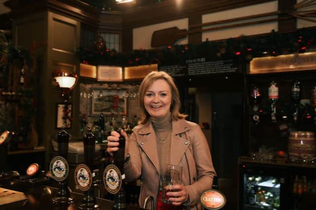 International Trade Secretary Liz Truss pulls a pint in The Woolpack on her visit to the Emmerdale Studios in Leeds. Pic: Jonathan Gawthorpe