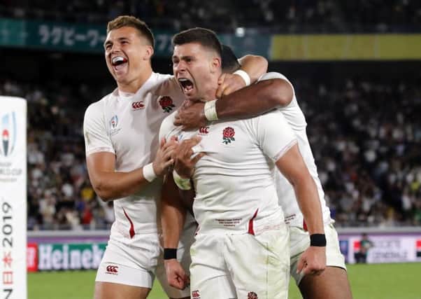 England's Ben Youngs, right, celebrates with teammates after scoring a try during the Rugby World Cup semifinal at International Yokohama Stadium (AP Photo/Christophe Ena)