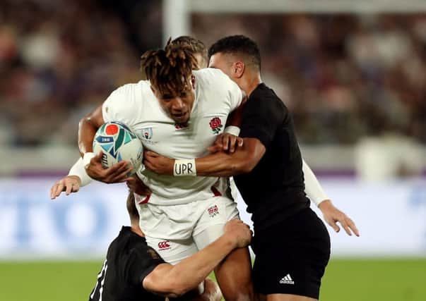 England's Anthony Watson is tackled by New Zealand's George Bridge (left).