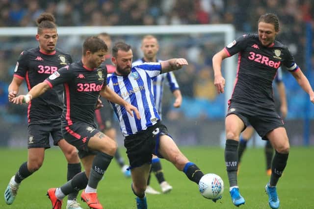 Sheffield Wednesday's Steven Fletcher (centre) battles against several Leeds United players, including Gaetano Berardi and Luke Ayling, far right.. Picture: Danny Lawson/PA
