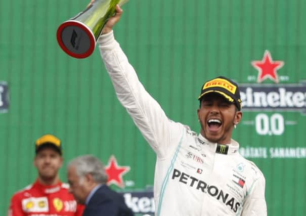 Mercedes driver Lewis Hamilton celebrates after winning the Formula 1 Mexico Grand Prix.