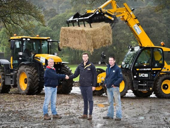 Pictured left to right: Forage Aid chairman Andrew Ward, JCB Fastrac sales engineer Sam Ullyott and farmer Michael Atkinson, of Reeth, with a JCB 542-70 AGRI Super Loadall and one of the Fastrac 4220 tractors  loaned to help the clear-up in Yorkshire. Picture courtesy of JCB.