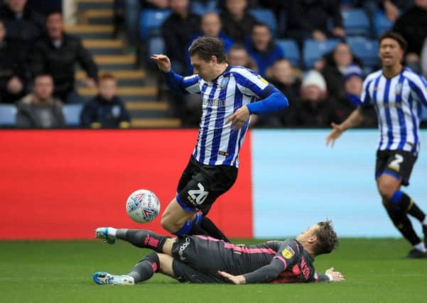 Sheffield Wednesday's Adam Reach (20) and Leeds United's Ezgjan Alioski battle for the ball at Hillsborough on Saturday. Picture: Danny Lawson/PA