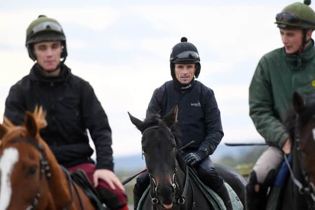 Jockey Sean Quinlan (centre) is due to ride Top Ville Ben in the Charlie Hall Chase.