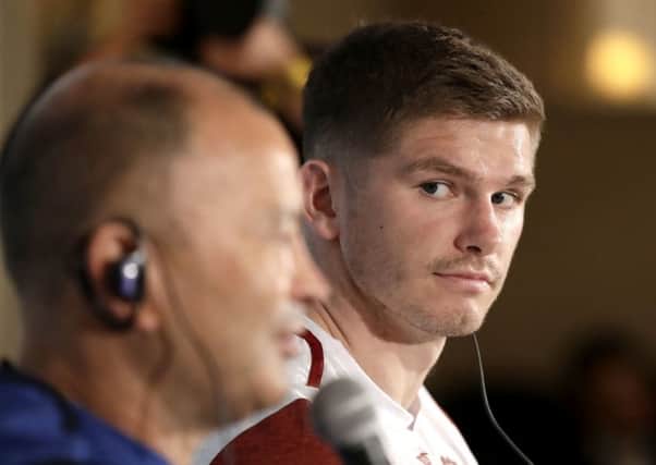 England captain Owen Farrell, right, looks at coach Eddie Jones and during a press conference in their team hotel in Tokyo. Picture: AP/Mark Baker