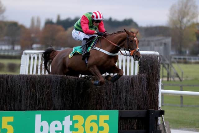 Definitly Red and Danny Cook clear the last in the 2018 Charlie Hall Chase at Wetherby.