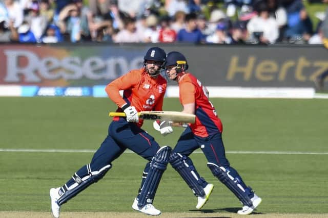 England's Eoin Morgan, right, and James Vince pass each other during their partnership in the seven-wicket win over hosts New Zealand in the first T20 international at Hagley Oval. Picture: Martin Hunter/Photosport via AP