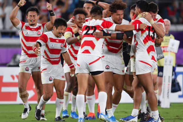 MAGIC MOMENT: Japan celebrate at the final whistle after their 28-21 defeat of Scotland at the Yokohama Stadium. Picure: Ashley Western/PA