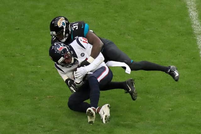 Houston Texans' DeAndre Carter (bottom) is tackled down by Jacksonville Jaguars' Breon Borders at Wembley.