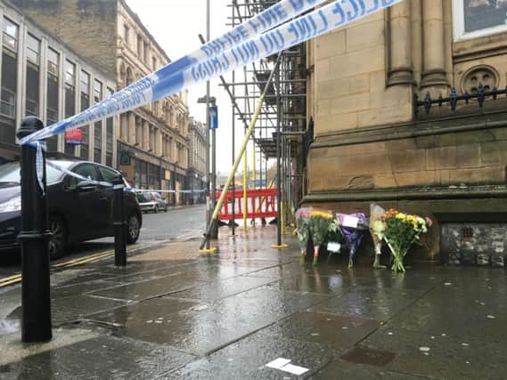 Floral tributes have been laid at the scene of the altercation in Halifax town centre. Credit: Sam McKeown.