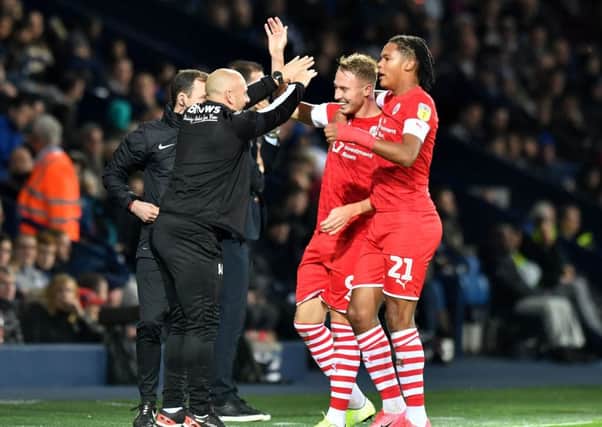 Uniified: Caretaker manager Adam Murray, front left, celebrates with Cauley Woodrow, front right, after his second goal in the creditable 2-2 draw at West Brom last month. (Picture: PA)