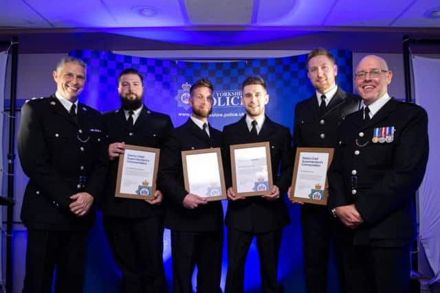 The officers receive their award for bravery.