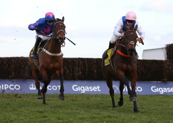 Waiting Patiently and Brian Hughes (right) lead Cue Card and Paddy Brennan away from the last fence before going on to win  the Ascot Chase . Picture: Julian Herbert/PA Wire.