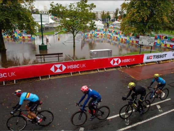 The men's cycling race passes the waterlogged Stray.