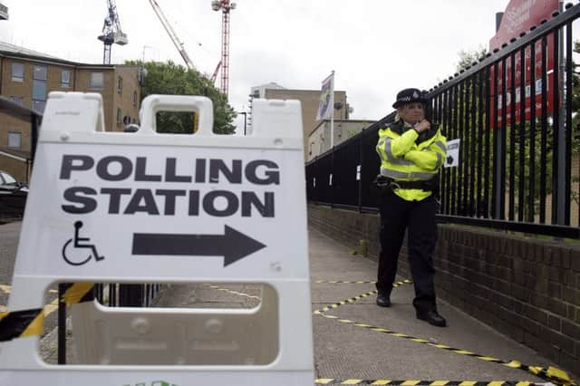 A police officer stationed outside a polling station at St Saviour's School in Poplar, London, as people cast their votes in the 2017 General Election. Picture: Victoria Jones/PA Wire