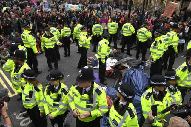 Extinction Rebellion protesters chained together as they block the road outside Westminster Abbey on October 7, 2019 in London, England. Climate change activists gathered to block access to various government departments as they start a two week protest in central London Credit:Chris J Ratcliffe/Getty Images