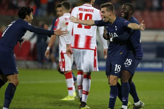 Tottenham's Giovani Lo Celso, second right, Tanguy Ndombele, right, and Son Heung-min, left, celebrate after Lo Celso scored a goal against Red Star during their Champions League group B game. (AP Photo/Marko Drobnjakovic)
