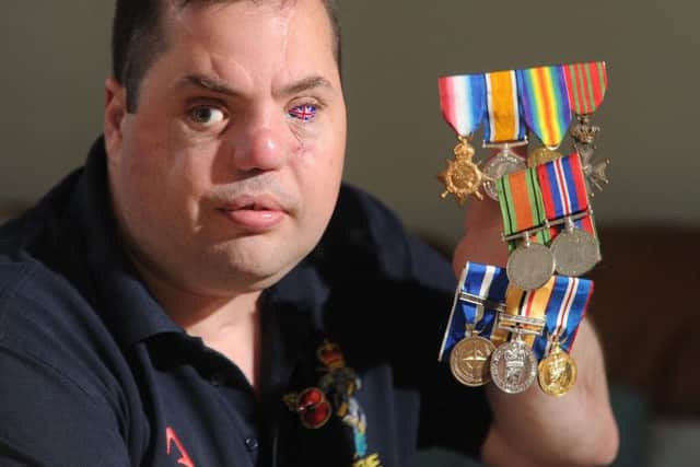 Simon Brown pictured with his own medals and those of his grandfather and great-grandfather who fought in both the World Wars. Picture Tony Johnson